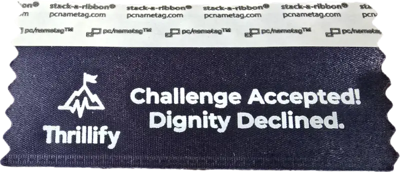 A badge ribbon with the Thrillify logo and the text 'Challenge Accepted! Dignity Decline.'