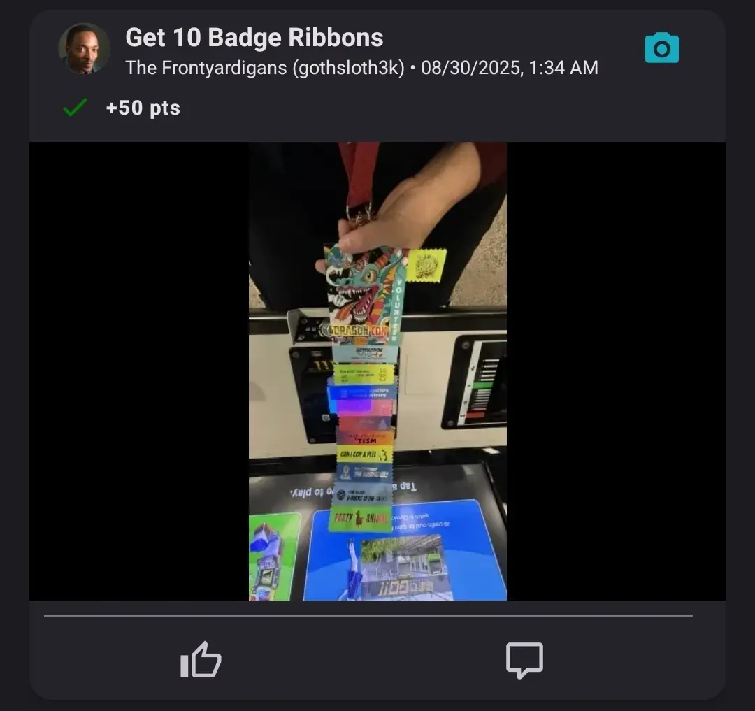 A hand holding a long stack of colorful convention badge ribbons attached to an event badge
